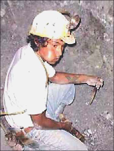 Bolivian miner has his mouth full'